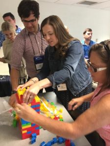 Institute of Organization Management first year attendees Mike Spence, Katie Blevins and Karen Gifford build a lego tower during a leadership team building exercise.  Photo by Marilyn Hunter