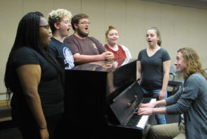  Student chorus members for the SFA School of Theatre's presentation of "(Biedermann and) The Firebugs," from left, Nychollete Easter, Houston freshman; Bayley Owen, Royce City sophomore; chorus leader James Burns, Troup senior;  Kaitlyn Kirby, Plano senior; and Caitlin Bice, Flint senior, rehearse with junior music composition major Jesse Edwards, who has written the music for the show.