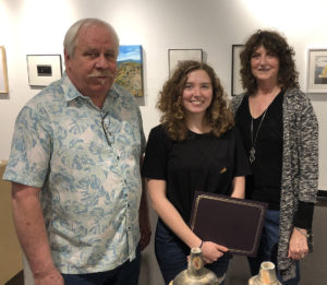 David Cozadd, president of the SFA Friends of the Visual Arts board, and Linda Mock, FVA scholarship committee chair, present the Robert Kinsell Art Scholarship to Chloe Garrett, a sophomore art student from Orange.
