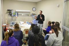 Justin Pelham, a clinical instructor for Stephen F. Austin State University’s food, nutrition and dietetics program, discusses how the medical equipment works and correlates with nutrition during a simulation in the DeWitt School of Nursing.