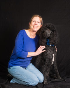 Nacogdoches HOPE treasurer Kathy Griffin and her poodle, Babette, get their photo taken during the Help-Portrait event. Getting the correct exposure for a black dog against a black background was a technical challenge.