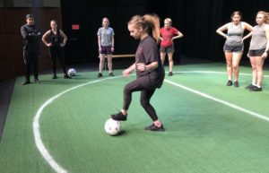 Dallas sophomore Michael Nunez and Colleyville freshman Aubrie Smith, from left, run soccer drills with "The Wolves" cast members Jordyn Averitte, Baytown senior; Emmeline Sullivan, Nacogdoches junior; Kathleen McNamara, Irving senior; Maddy Moore, Mesquite freshman; and Britney Day, Lufkin sophomore. Sarah DeLappe's play will be presented at 7:30 p.m. Tuesday through Saturday, Oct. 1 through 5, in W.M. Turner Auditorium on the SFA campus.