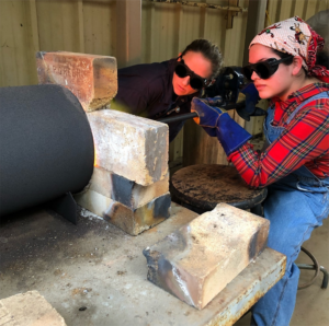 Madeline Castillo, right, recent graduate in the SFA School of Art, pictured with Lauren Selden, professor of metalworking and jewelry in the School of Art, has been accepted into a prestigious M.F.A. program in art at Texas Tech University.