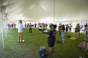 Dr. Michael Murphy, director of choral activities at SFA, conducts rehearsals under a tent on campus while students practice social distancing and follow other CDC protocols to prevent the spread of COVID-19.