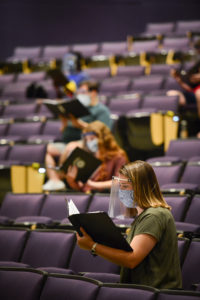 SFA A Cappella Choir member Marissa Harry, sophomore from Mansfield, and fellow voice students rehearse while following Centers for Disease Control and Prevention guidelines, including wearing face masks along with face shields as an extra precaution.