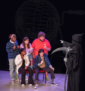 In a rehearsal moment, five actors question which of them will be chosen by Death to play the title role in a particular performance of "Everybody" by Branden Jacobs-Jenkins. From left are, seated, Waxahachie junior Kiya Green; Denton junior Connor Molen; standing, Texarkana junior Daun Whaley; San Antonio junior Hannah Marfin; Baytown junior Joshua Harris; and far right, Sugar Land freshman Anthony Krosecz as Death.